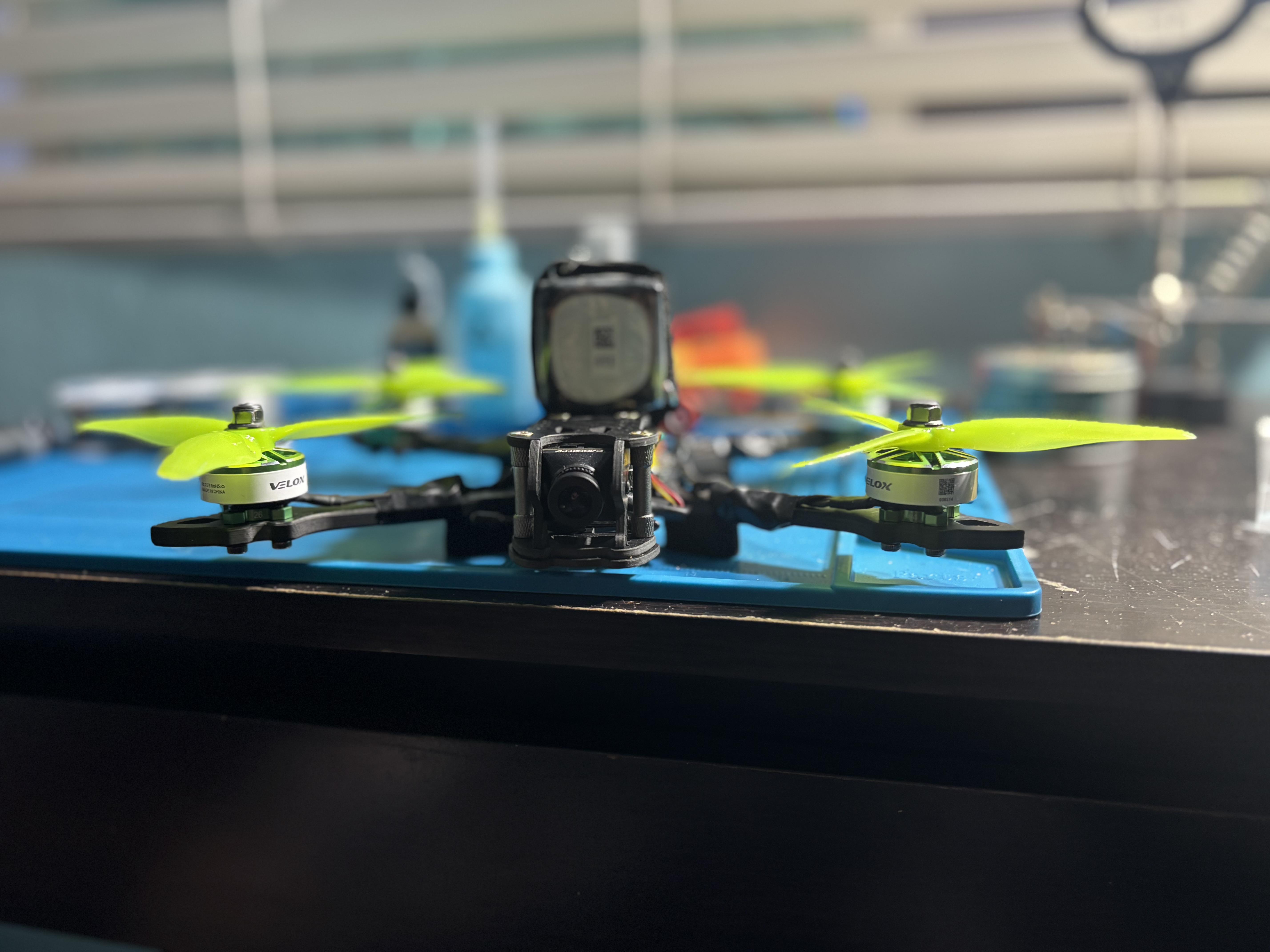 Front view of the FPV drone showing the Caddx analog camera and T-Motor Velox motors